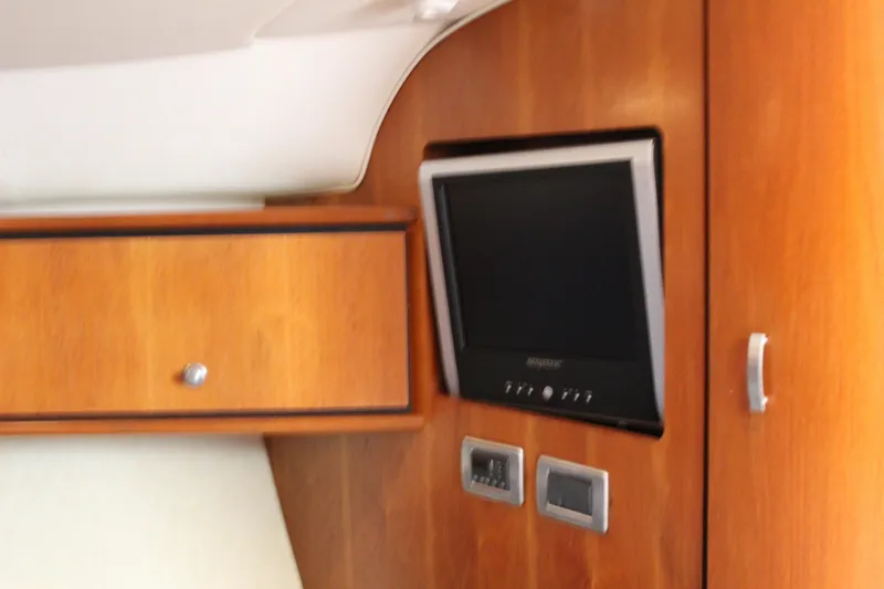 Slide: The Image of 2008 Tiara Yachts 3500 Sovran interior with wooden cabinetry and built-in television. - 37