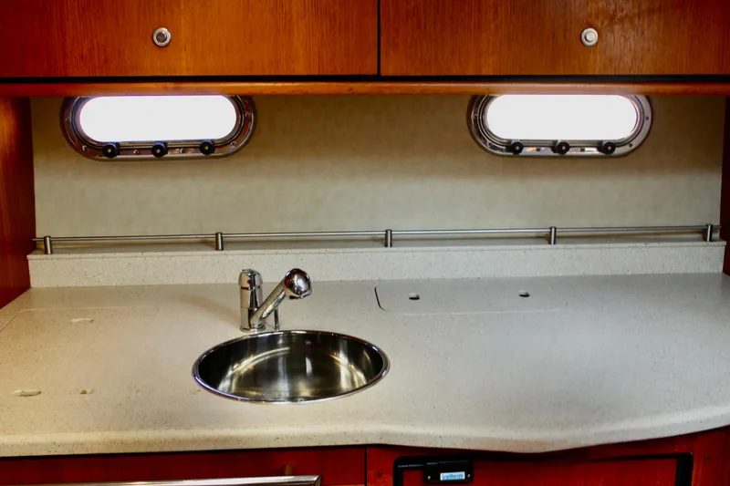 Slide: The Image of 2008 Tiara Yachts 3500 Sovran kitchen with sink and wooden cabinetry. - 38