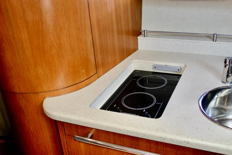 Slide: The Image of 2008 Tiara Yachts 3500 Sovran kitchen with sleek cooktop and modern sink. - 39