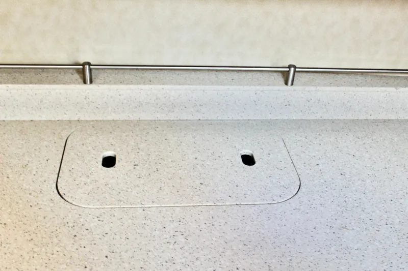 Slide: The Image of 2008 Tiara Yachts 3500 Sovran countertop with integrated sink cover and metal rail. - 40