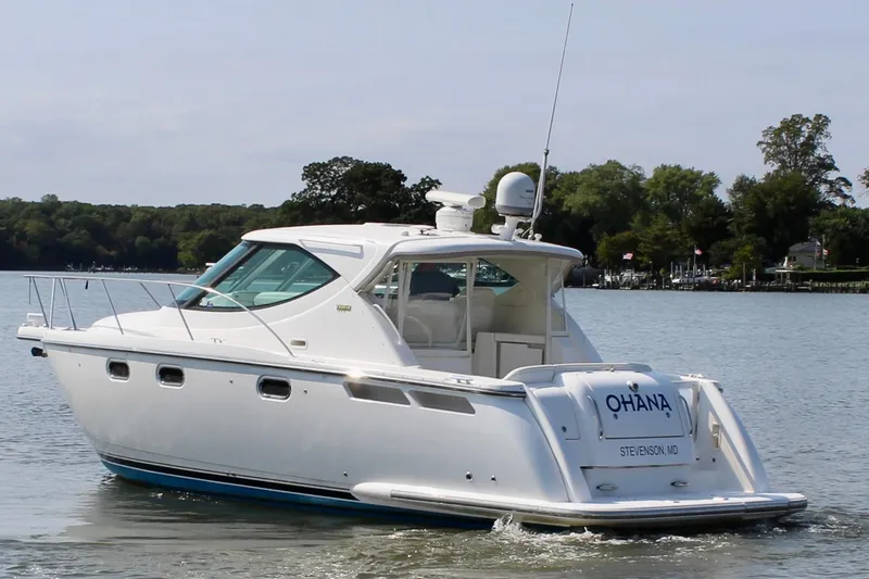 Slide: The Image of 2008 Tiara Yachts 3500 Sovran cruising on a calm lake with scenic background. - 5