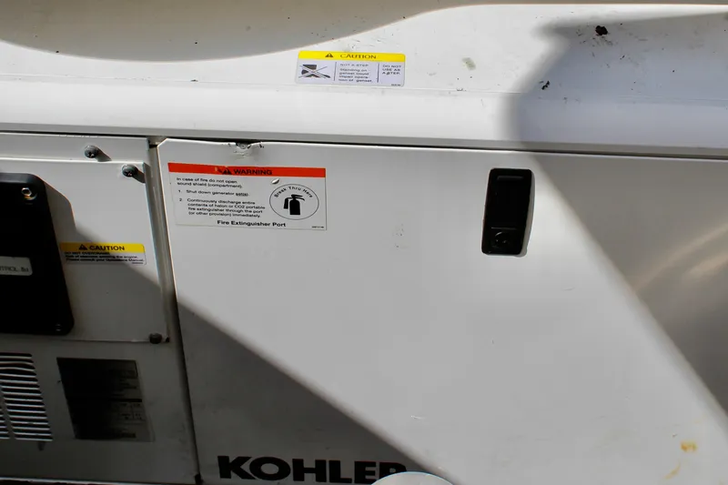 Slide: The Image of Engine compartment of 2008 Tiara Yachts 3500 Sovran with Kohler generator and safety warnings. - 50