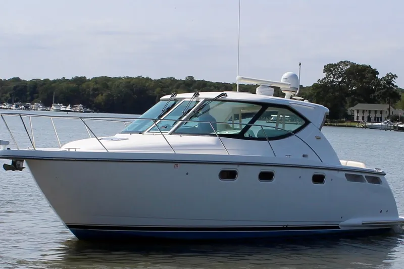 Slide: The Image of 2008 Tiara Yachts 3500 Sovran cruising on a calm lake with scenic background. - 7