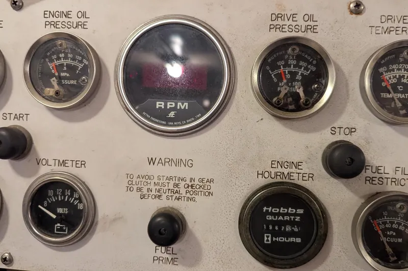 Slide: The Image of Control panel of a 1992 Viking 65 Motor Yacht with gauges and warning labels. - 10