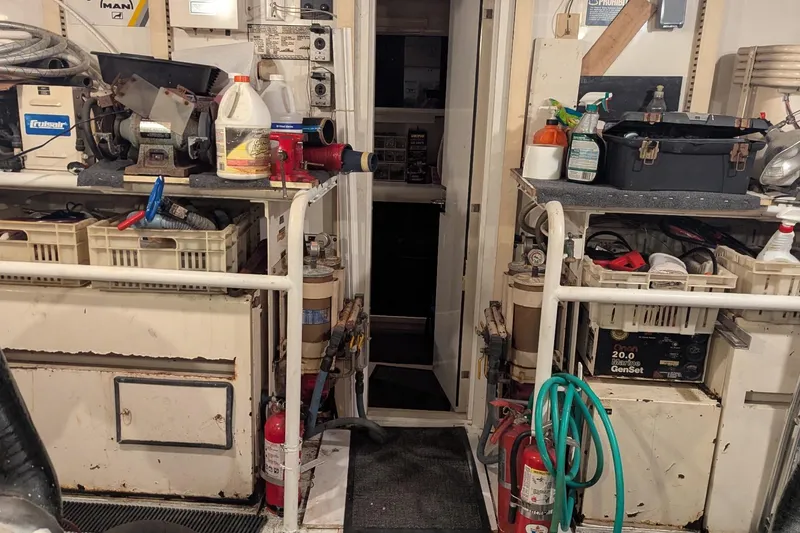 Slide: The Image of Engine room of a 1992 Viking 65 Motor Yacht with tools and equipment. - 14