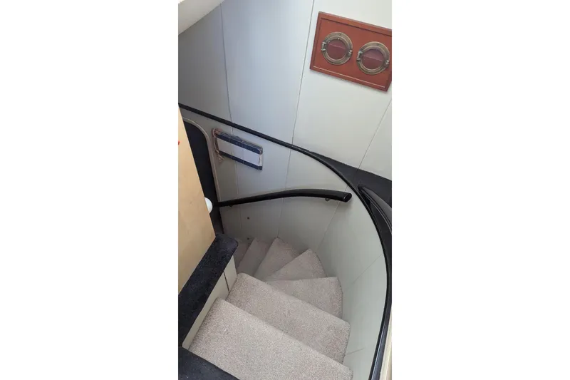 Slide: The Image of Staircase inside 1992 Viking 65 Motor Yacht with carpeted steps and wooden accents. - 18