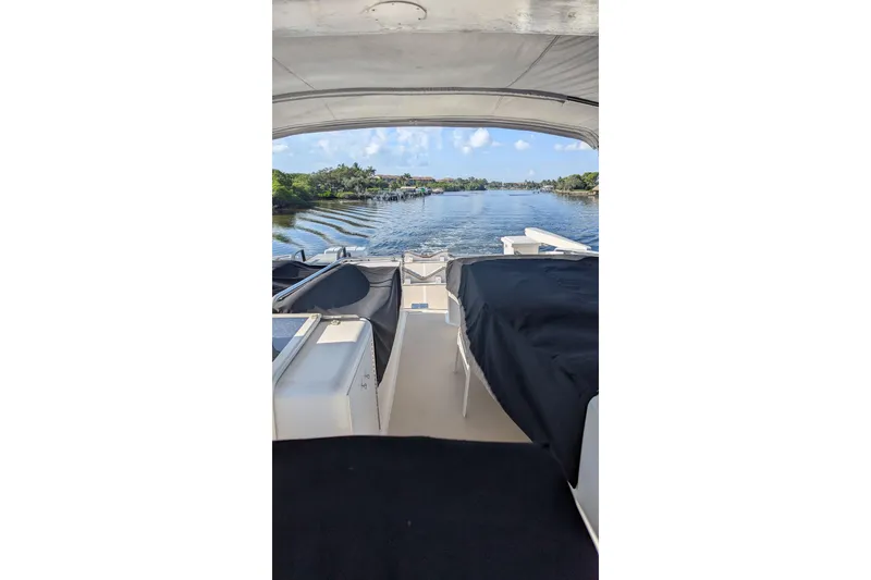 Slide: The Image of 1992 Viking 65 Motor Yacht interior view with scenic waterway backdrop. - 22