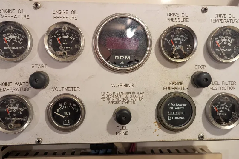 Slide: The Image of Control panel of a 1992 Viking 65 Motor Yacht with gauges and switches. - 28