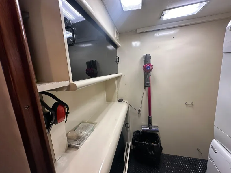 Slide: The Image of Laundry room in a 1992 Viking 65 Motor Yacht with shelves and cleaning equipment. - 4