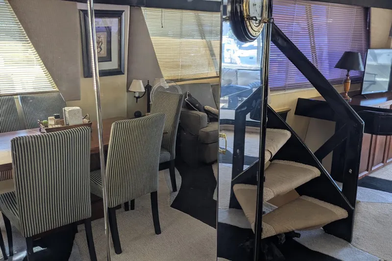 Slide: The Image of Interior of 1992 Viking 65 Motor Yacht with elegant dining area and spiral staircase. - 5