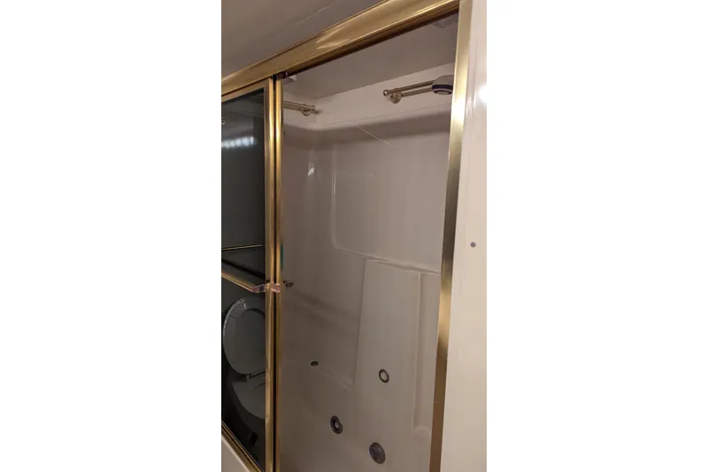Slide: The Image of Shower area in 1992 Viking 65 Motor Yacht with gold trim. - 6