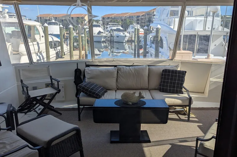 Slide: The Image of Interior of 1992 Viking 65 Motor Yacht with comfortable seating and marina view. - 8