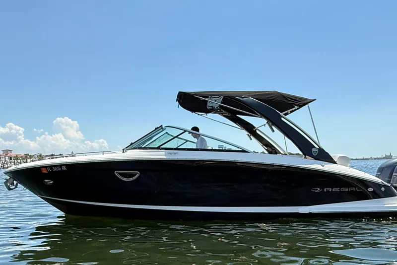 The Image of 2017 Regal 29 OBX boat on calm water under clear blue sky. - 0