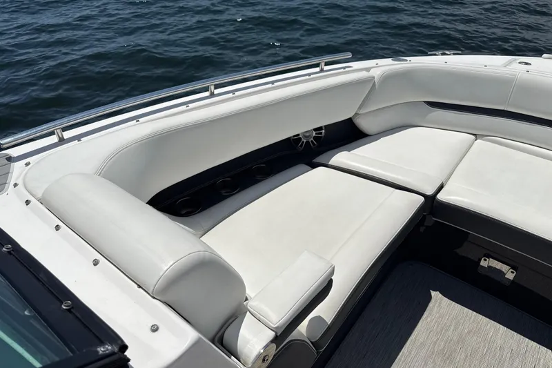 Slide: The Image of 2017 Regal 29 OBX boat interior with white cushioned seating on open water. - 10