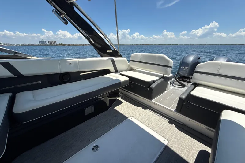Slide: The Image of 2017 Regal 29 OBX boat interior with seating, overlooking calm waters. - 18