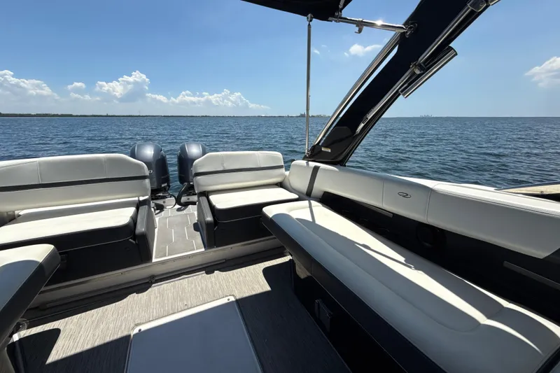 Slide: The Image of 2017 Regal 29 OBX boat interior with seating, overlooking calm blue waters. - 19