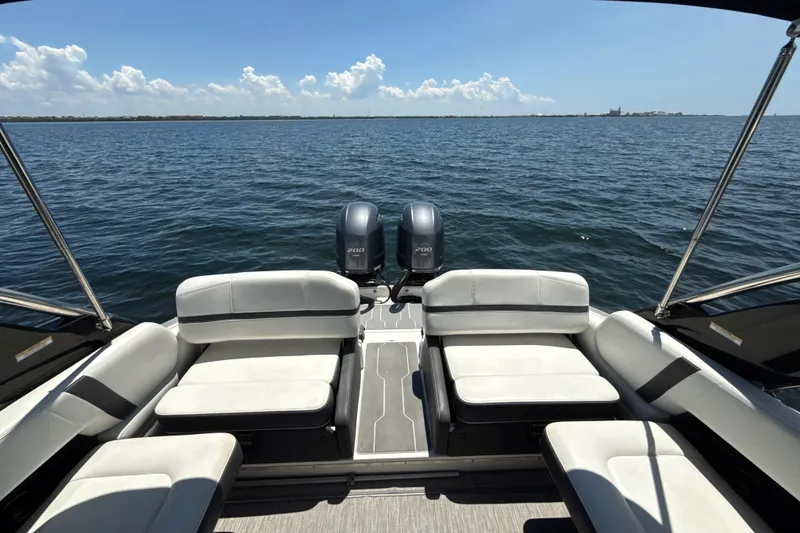 Slide: The Image of 2017 Regal 29 OBX boat with dual engines on open water, featuring spacious seating. - 20