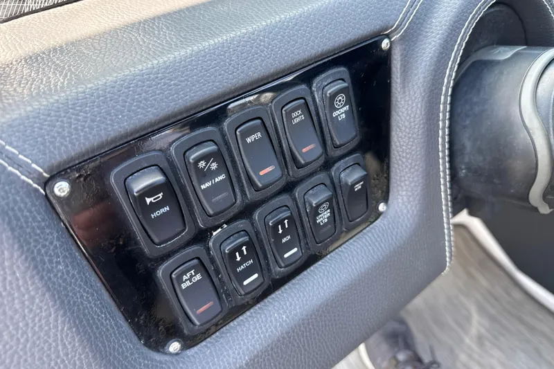 Slide: The Image of Control panel of a 2017 Regal 29 OBX boat with various switches. - 26
