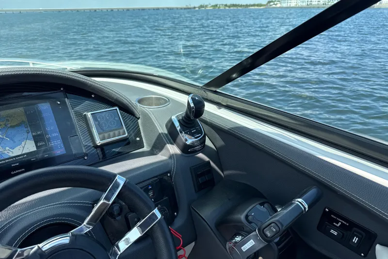 Slide: The Image of 2017 Regal 29 OBX boat dashboard with navigation system on open water. - 29