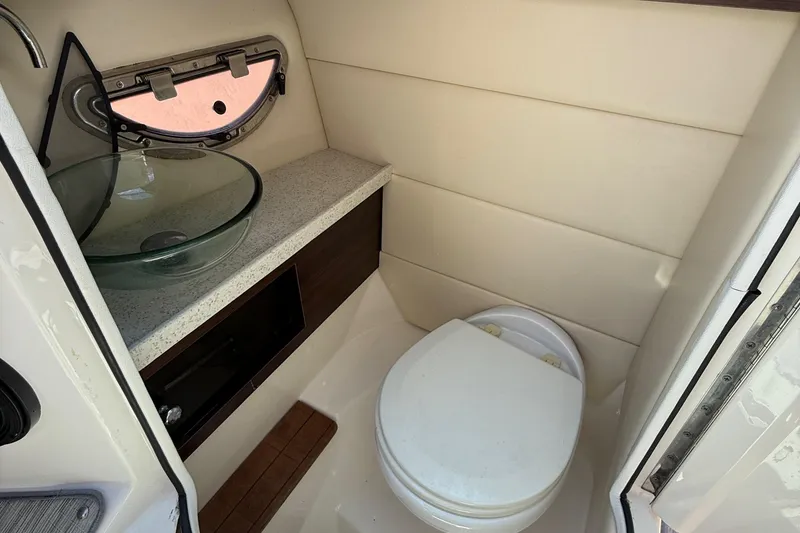 Slide: The Image of 2017 Regal 29 OBX boat bathroom with glass sink and compact toilet. - 31