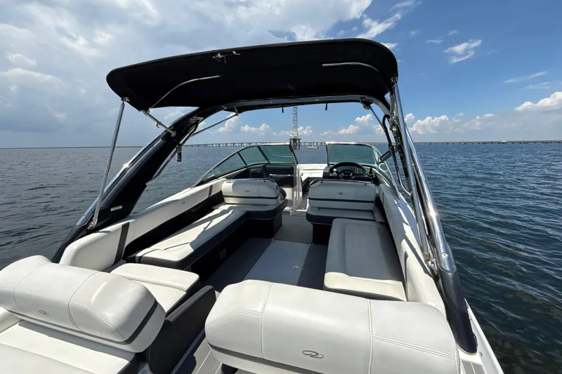 Slide: The Image of 2017 Regal 29 OBX boat with spacious seating on open water under a clear sky. - 5