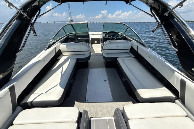 Slide: The Image of 2017 Regal 29 OBX boat interior with spacious seating on calm water. - 6