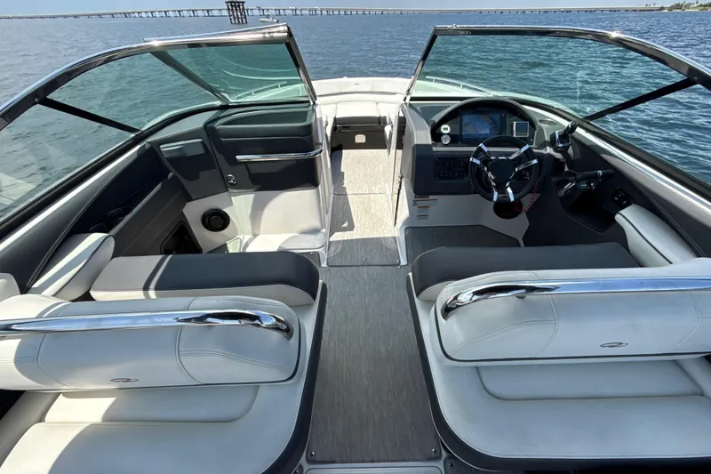 Slide: The Image of 2017 Regal 29 OBX boat interior with sleek seating and modern dashboard on open water. - 7