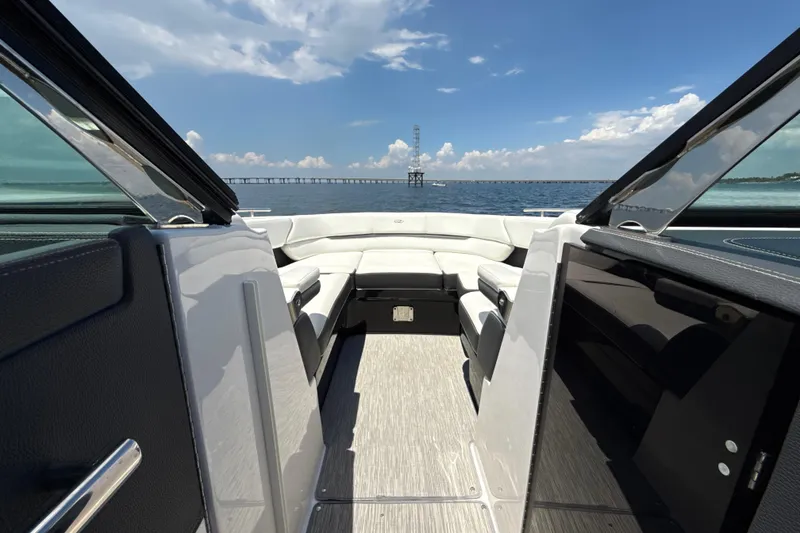 Slide: The Image of 2017 Regal 29 OBX boat interior with open deck, overlooking calm sea and blue sky. - 8