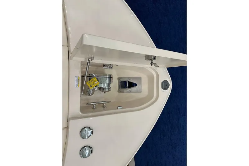 Slide: The Image of 2026 Grady-White Canyon 271 boat anchor compartment with open hatch and visible hardware. - 18