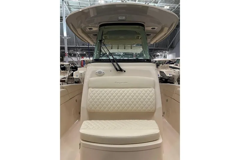 Slide: The Image of 2026 Grady-White Canyon 271 boat interior with cushioned seating and windshield. - 19