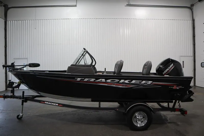 Slide: The Image of 2023 Tracker Pro Guide V-16 WT boat in a showroom, side view. - 10