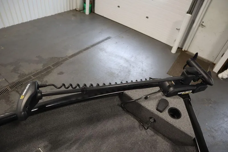 Slide: The Image of 2023 Tracker Pro Guide V-16 WT boat with Minn Kota trolling motor in a garage. - 13