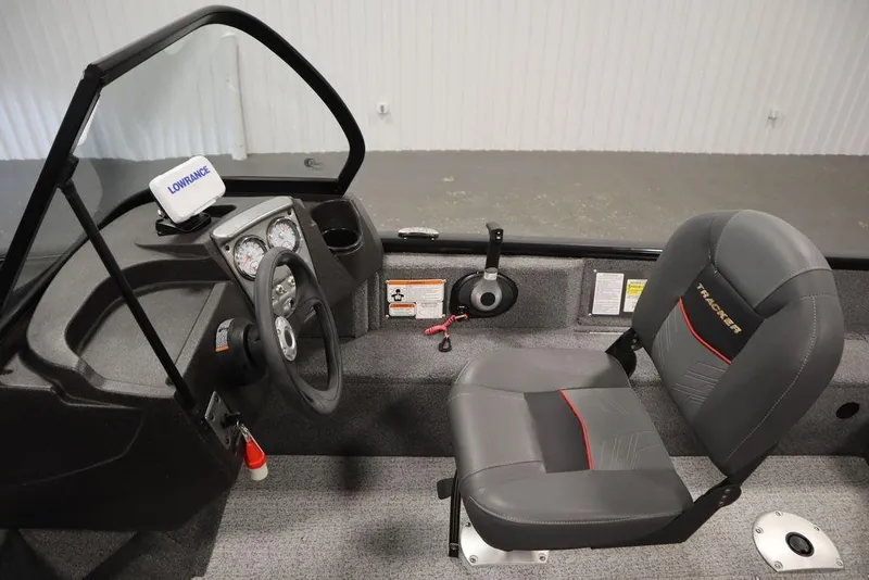 Slide: The Image of 2023 Tracker Pro Guide V-16 WT boat interior with steering wheel and seat. - 21