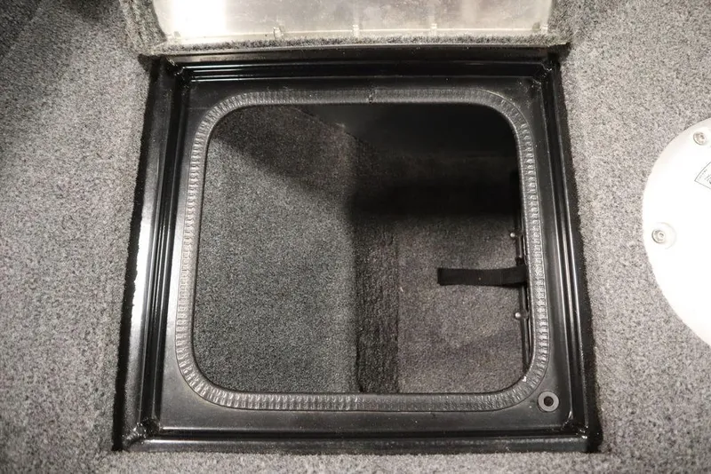 Slide: The Image of 2023 Tracker Pro Guide V-16 WT storage compartment with carpeted interior. - 23