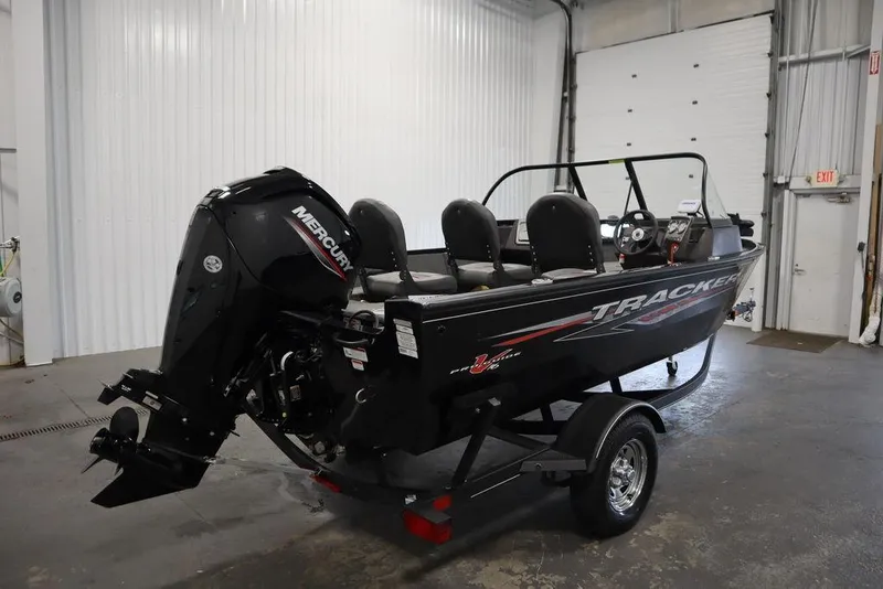 Slide: The Image of 2023 Tracker Pro Guide V-16 WT boat with Mercury engine in a garage setting. - 3