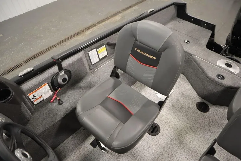 Slide: The Image of 2023 Tracker Pro Guide V-16 WT boat interior with gray seating and control panel. - 31
