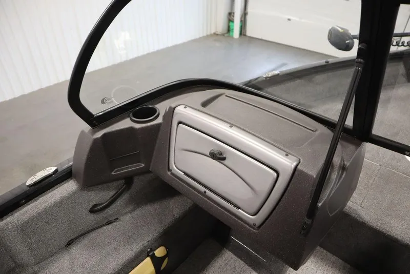 Slide: The Image of 2023 Tracker Pro Guide V-16 WT boat interior with windshield and storage compartment. - 32