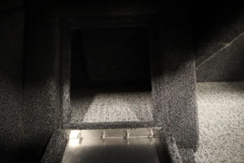 Slide: The Image of 2023 Tracker Pro Guide V-16 WT interior storage compartment, carpeted and spacious. - 35