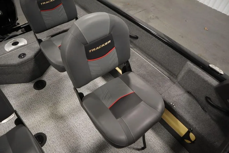 Slide: The Image of 2023 Tracker Pro Guide V-16 WT boat interior with gray seats and carpeted flooring. - 37