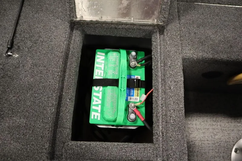 Slide: The Image of Battery compartment of 2023 Tracker Pro Guide V-16 WT boat, featuring Interstate battery. - 48