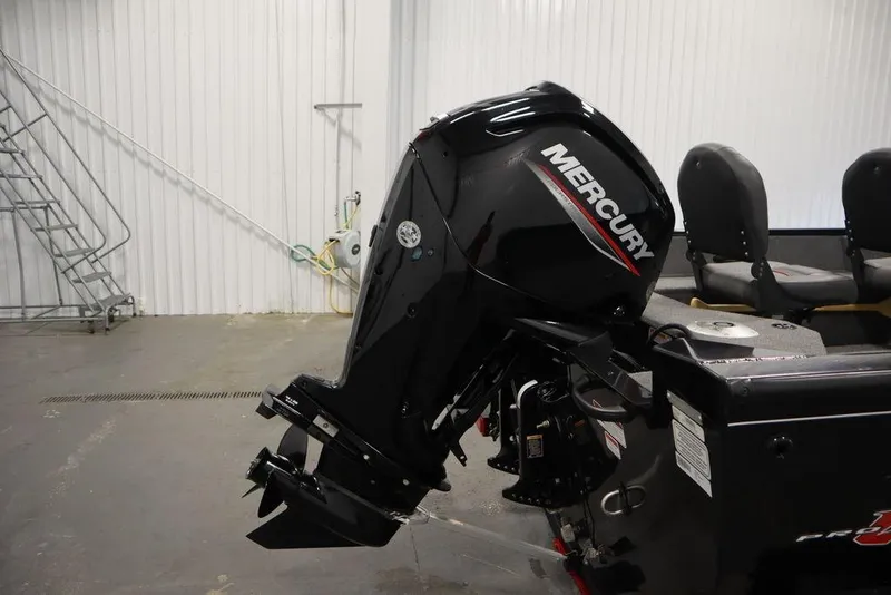 Slide: The Image of 2023 Tracker Pro Guide V-16 WT with Mercury outboard motor in a garage setting. - 49