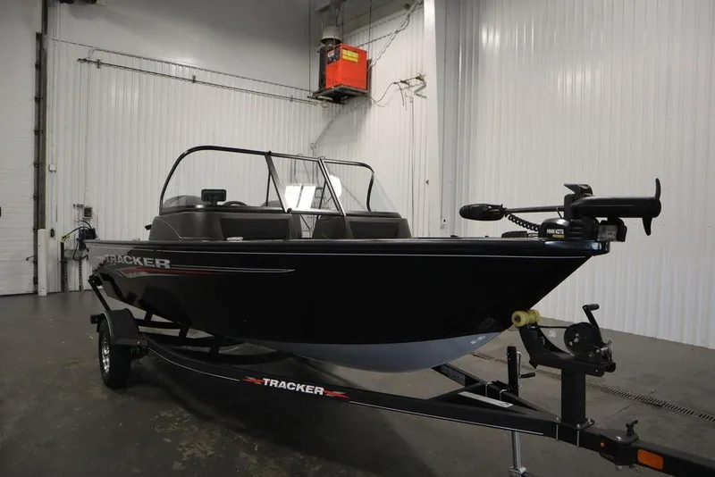 Slide: The Image of 2023 Tracker Pro Guide V-16 WT boat in a garage setting. - 5