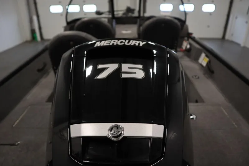 Slide: The Image of 2023 Tracker Pro Guide V-16 WT with Mercury 75 engine in a garage setting. - 50