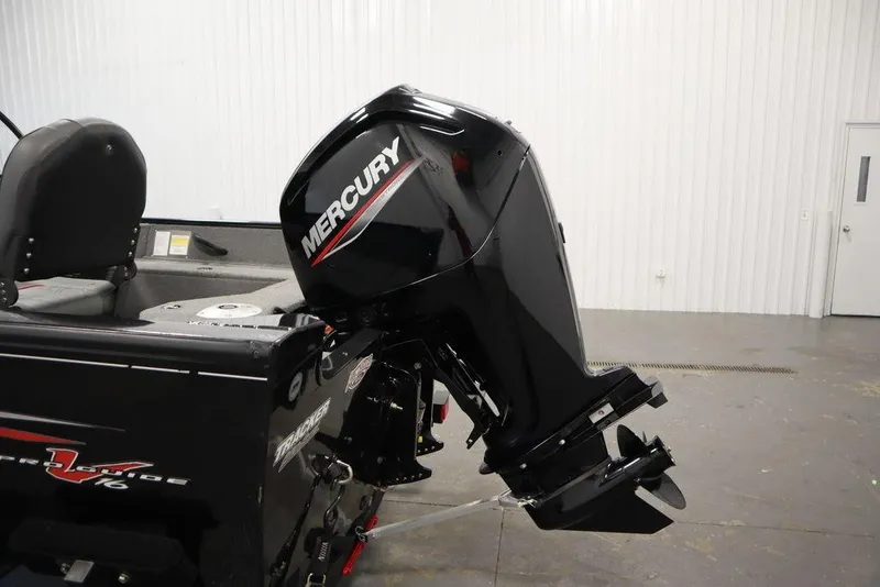 Slide: The Image of 2023 Tracker Pro Guide V-16 WT boat with Mercury outboard motor in a showroom. - 51