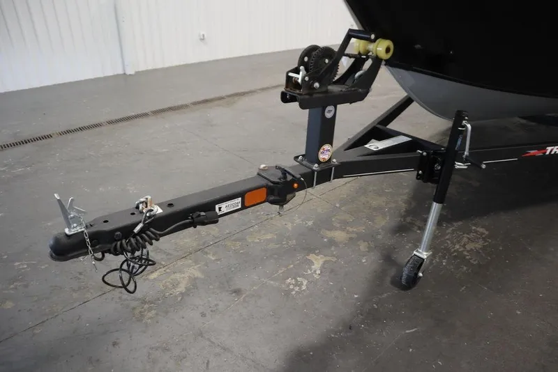 Slide: The Image of Trailer hitch of 2023 Tracker Pro Guide V-16 WT boat in a garage setting. - 55