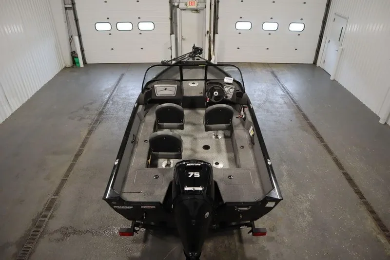 Slide: The Image of 2023 Tracker Pro Guide V-16 WT boat in a garage, featuring a 75 HP engine. - 7