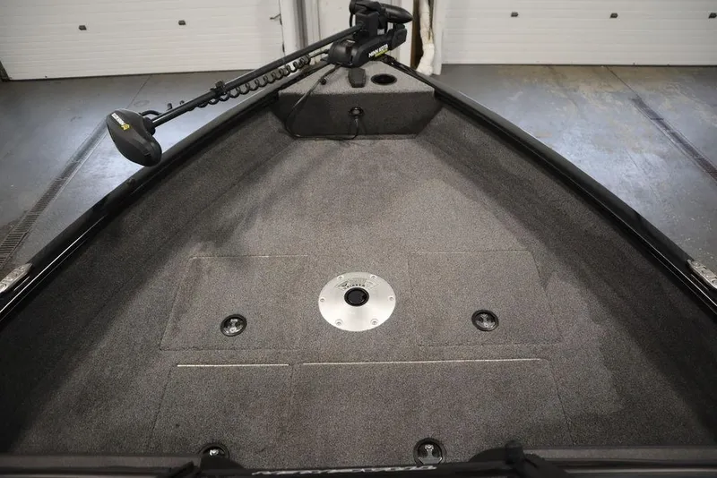 Slide: The Image of 2023 Tracker Pro Guide V-16 WT boat interior with trolling motor and storage compartments. - 8