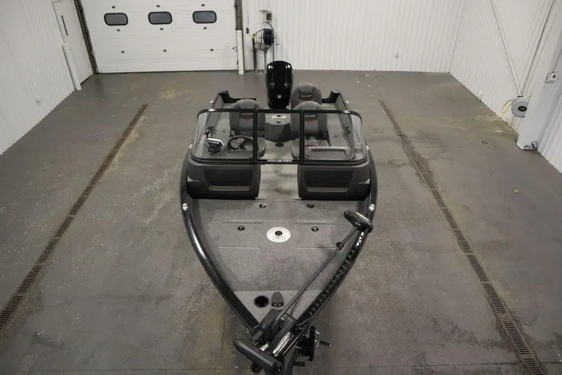 Slide: The Image of 2023 Tracker Pro Guide V-16 WT boat in a spacious indoor garage. - 9