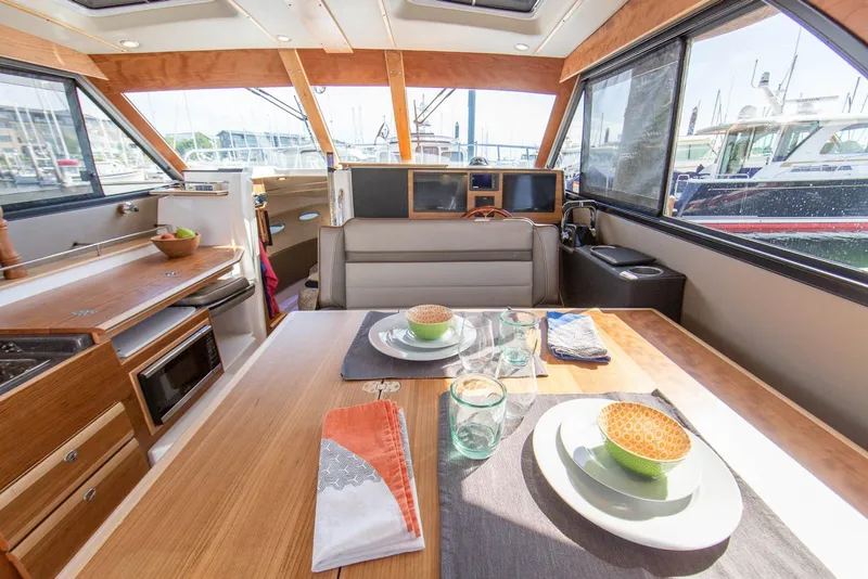 Slide: The Image of Interior of 2026 Cutwater C-32 CB yacht with dining setup and modern amenities. - 6