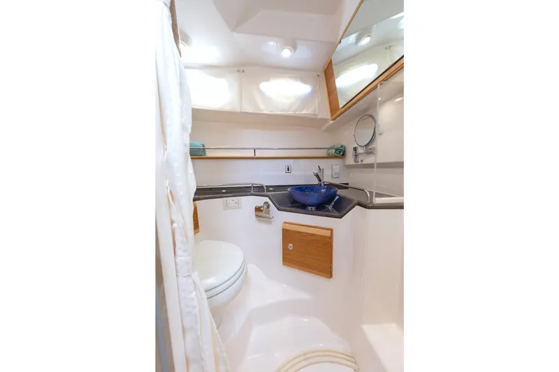 Slide: The Image of 2026 Cutwater C-32 CB boat bathroom with modern sink and toilet. - 8